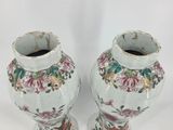 two vases that have been painted with flowers on them