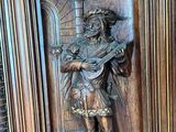 a statue of a man with a sword on a wall