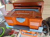an orange and blue tool box sitting on top of a table