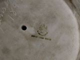 a close up of a white vase with writing on it