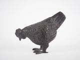 a black bird that is standing in the snow