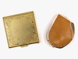 two pieces of gold and brown leather with a gold plate on top