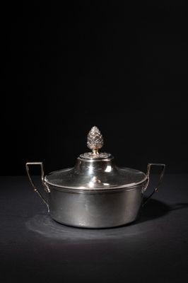 a silver plated casserole with a pine on top