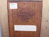 an old picture of a wooden frame with writing on it