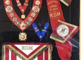a picture of a display case with a red and gold sash