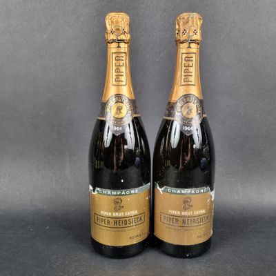 two bottles of champagne sitting on top of a table