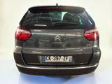 the rear of a grey citrole parked in a white room