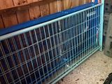a metal gate that has a blue cover on it