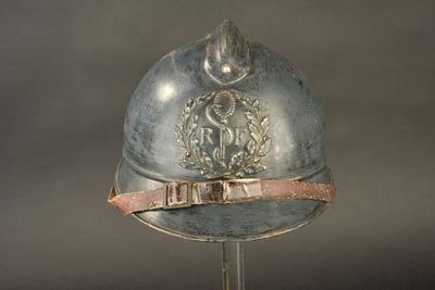 a silver helmet with a metal band around the neck