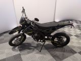 a picture of a motorcycle parked on a checkered floor