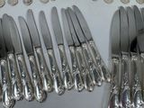a lot of silverware on a table with coins