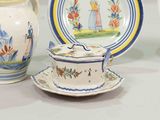 three plates and a teapot on a table