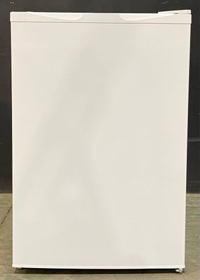 an image of a small white refrigerator in a room