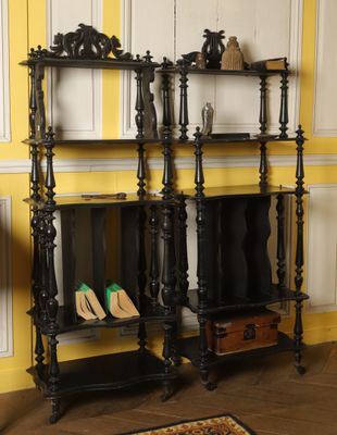 two shelves with shoes on them in the corner of a room