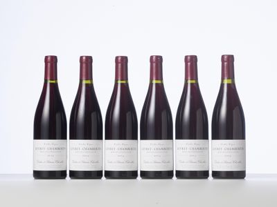 six bottles of red wine lined up in a row