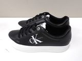 black leather sneakers with white soles and a monogram k logo on the side