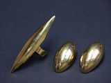 a close up of a pair of gold cufflinks and a pair of silver cufflinks