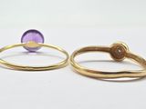 two gold rings with amethorate and amethorate on them