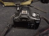 a camera that is sitting on the ground next to a bag