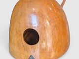 a wooden birdhouse with a hole in the middle of it