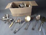 a box full of silver spoons and spoons on a table