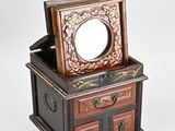 a small wooden box with a mirror on top of it