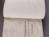 a hand holding a piece of paper over a piece of paper