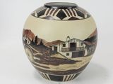 a vase that has a picture of a house on it