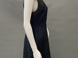 an image of a mannequin wearing a black dress on a mannequin stand