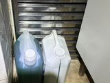 two containers of milk sitting next to each other on the floor