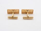 a pair of gold plated cufflinks