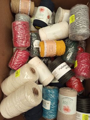many spools of yarn in a box together