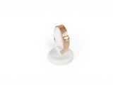 a close up of a ring on a stand on a white surface
