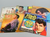 four elvis presley album covers are on a table