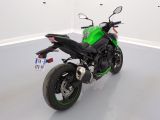 a green and black motorcycle parked in a white room