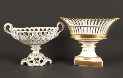 pair of white and gold vases on pedestals against a black background