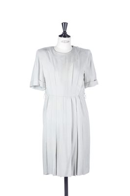 grey dress on a mannequin stand on a white background
