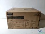 packaging of a microwave oven sitting on top of a white counter
