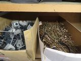 a box full of screws and nails on a shelf