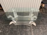 a glass table with a glass top on a tile floor