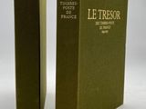 two books sitting on top of each other on a white surface