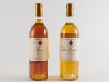 two bottles of wine sitting next to each other on a white surface