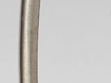 a silver and gold object on a white surface