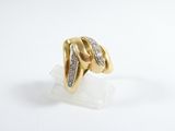 a close up of a gold ring with diamonds on a white surface