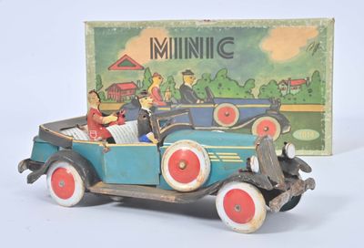 a toy car with people in it and a box in the background