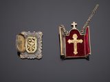two pieces of jewelry including a cross, a book, and a locke