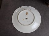 a white plate with a crack in it on a table