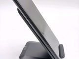 a cell phone that is sitting on top of a stand