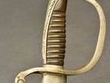 a close up of a sword with a gold handle