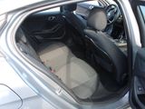 the interior of a car with the door open and the driver ' s seat down
